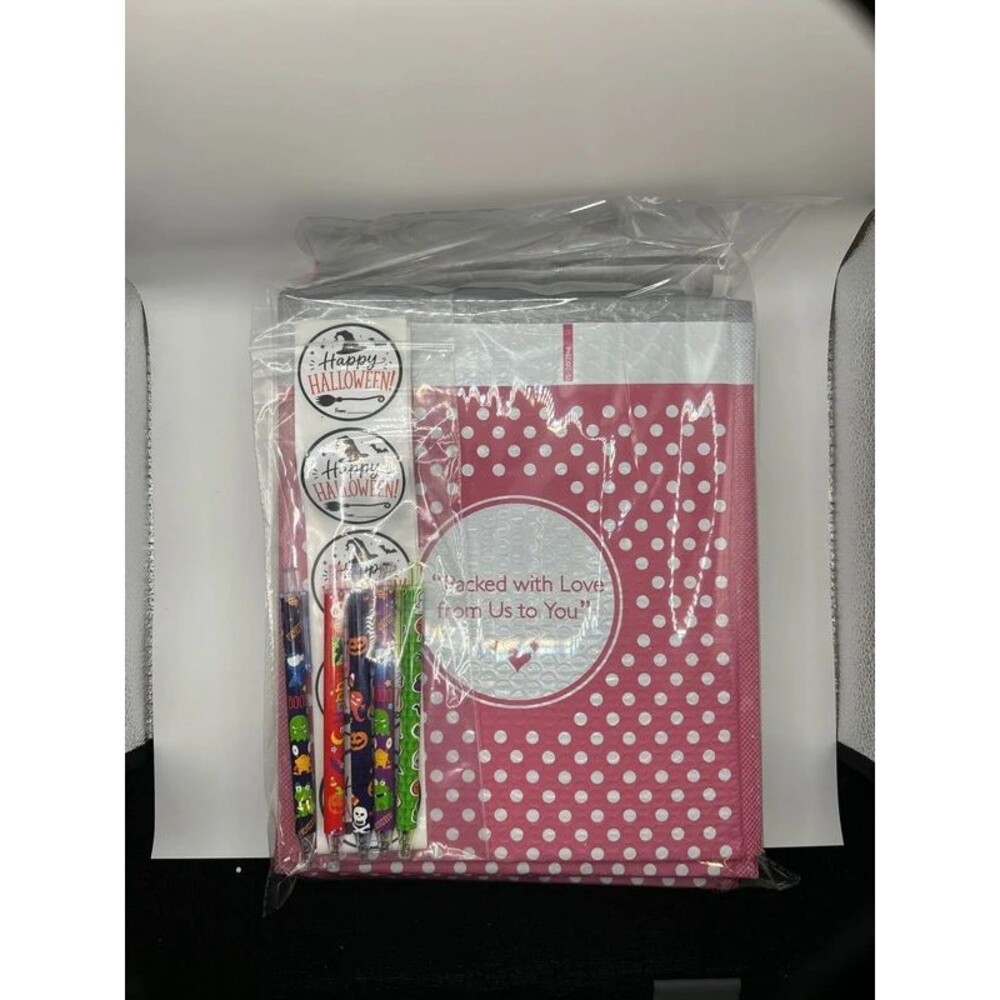 10 pack of pink polka dot bubble mailers with Halloween stickers and pens